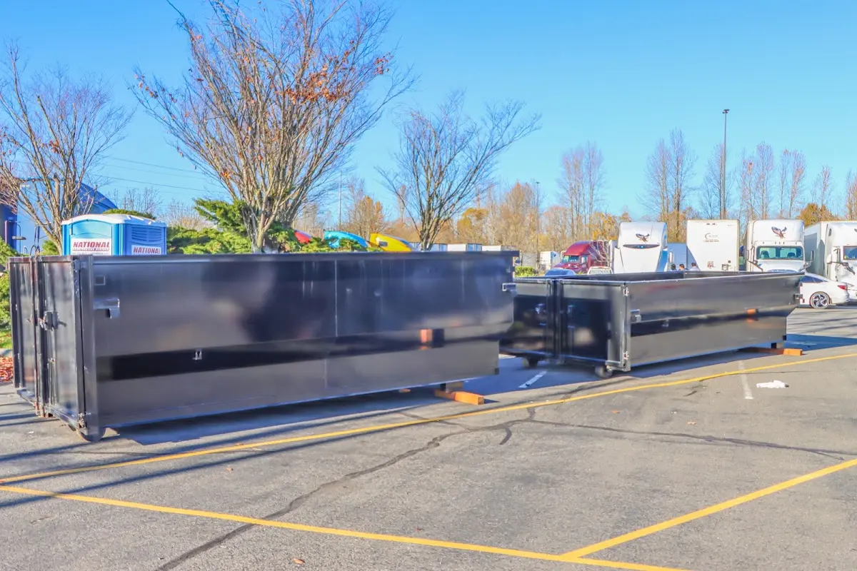 Professional dumpster rental service with roll-off container on residential driveway in Summit